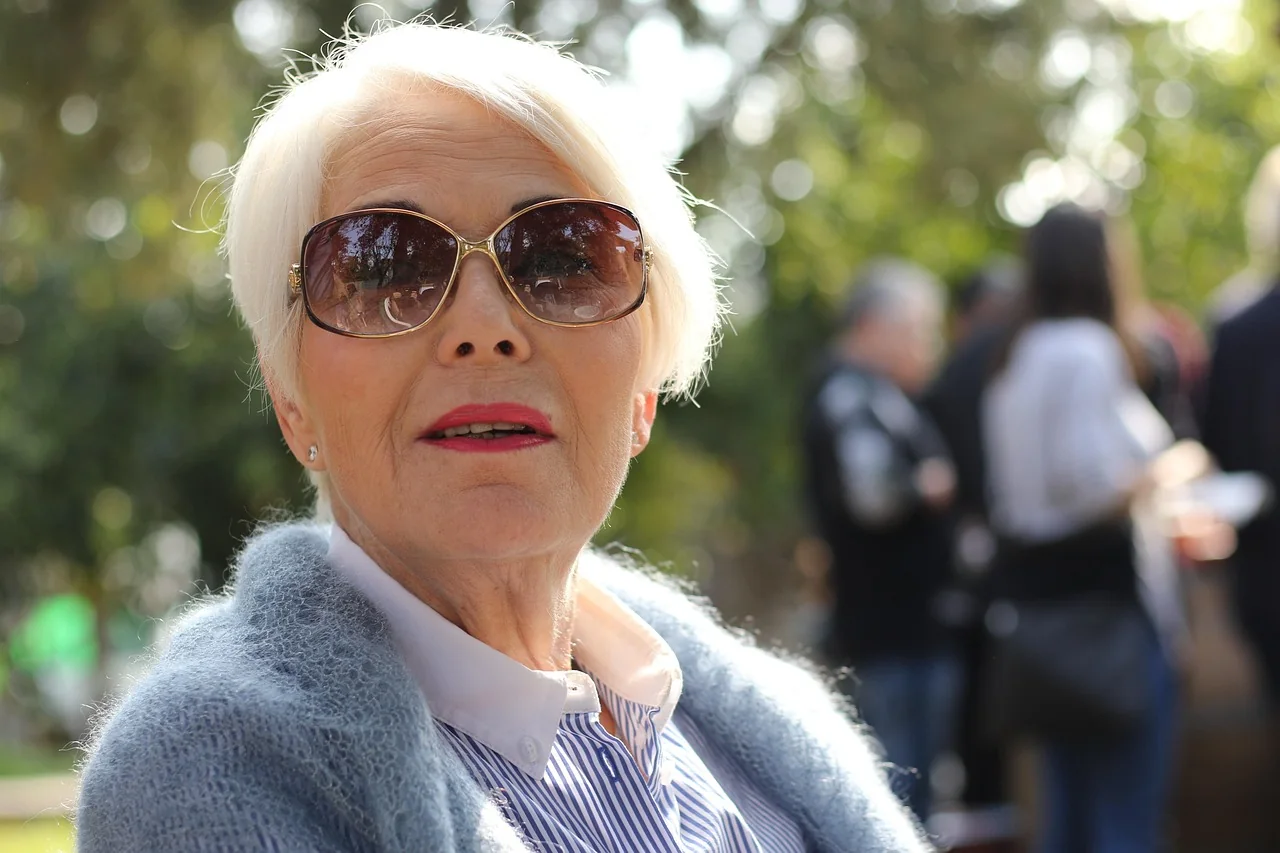 Older woman sitting outside on a bench